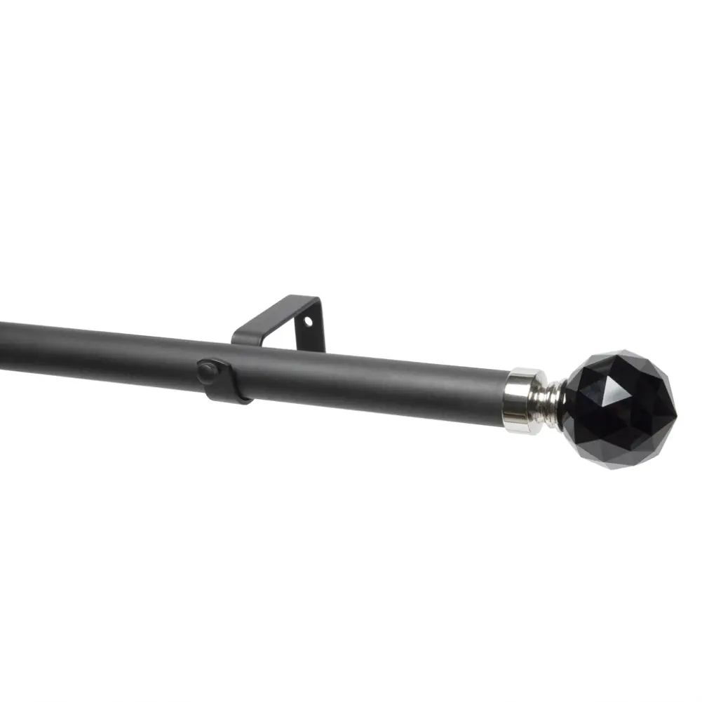 Black curtain pole with black crystal ball finial for elegant window decor.