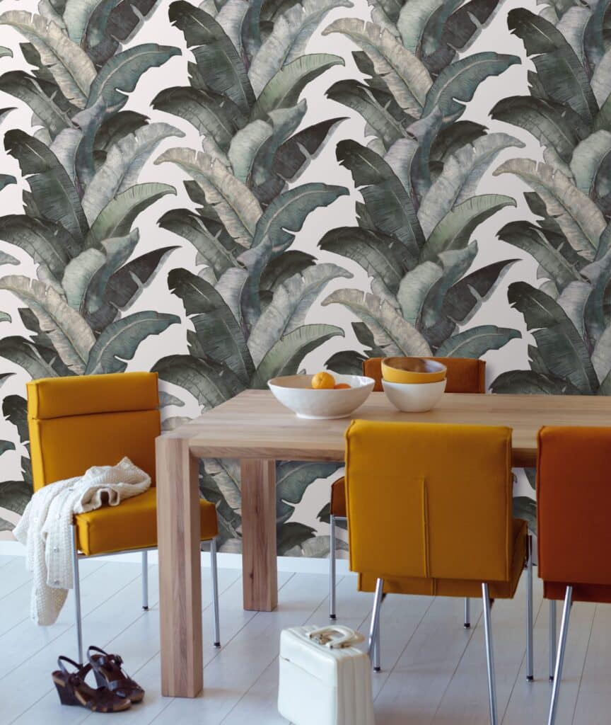 Plantation moss green wallpaper with banana leaf pattern in dining room.