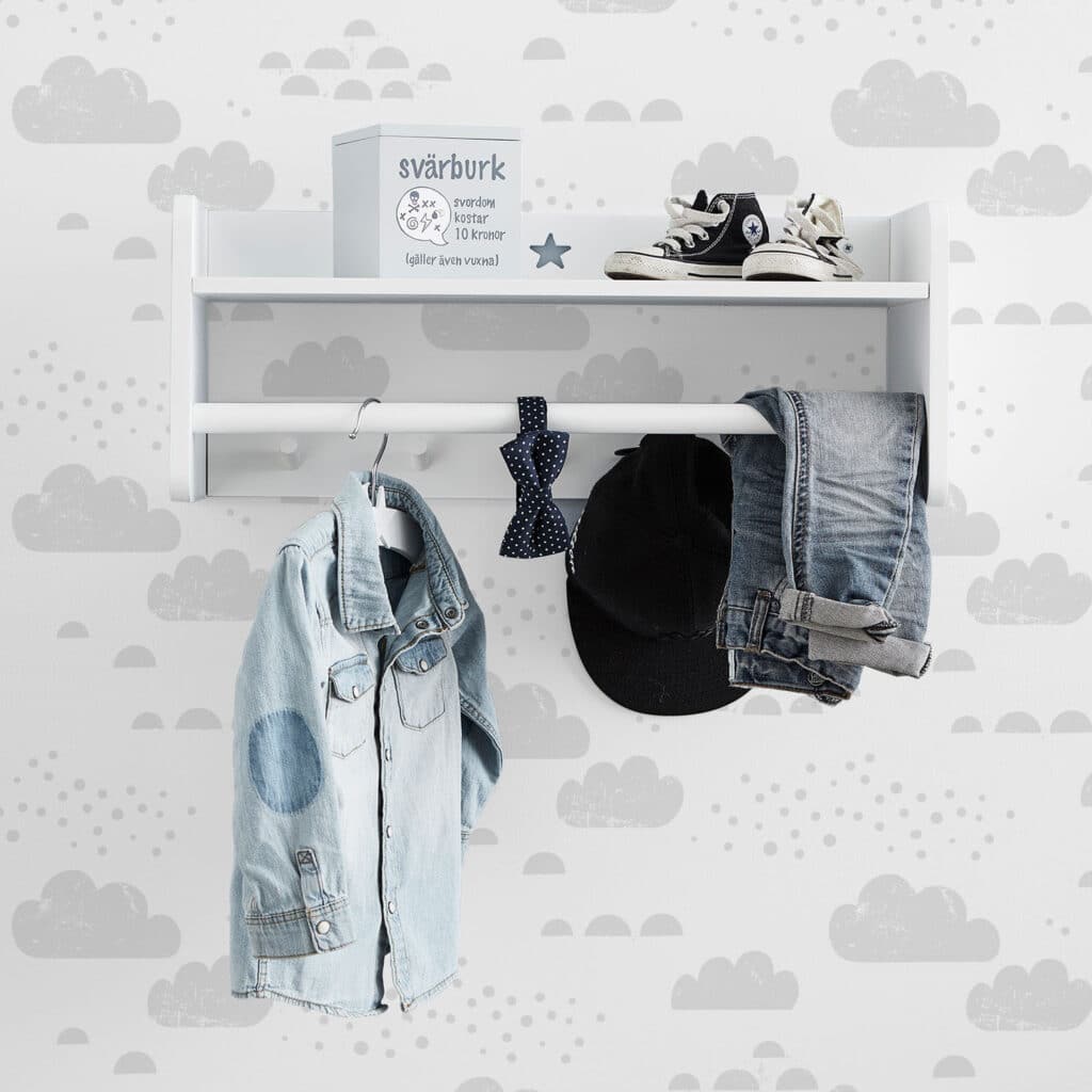 Kids wall decor with cloudy sky pattern, hooks, and shoes for nursery or child's room.