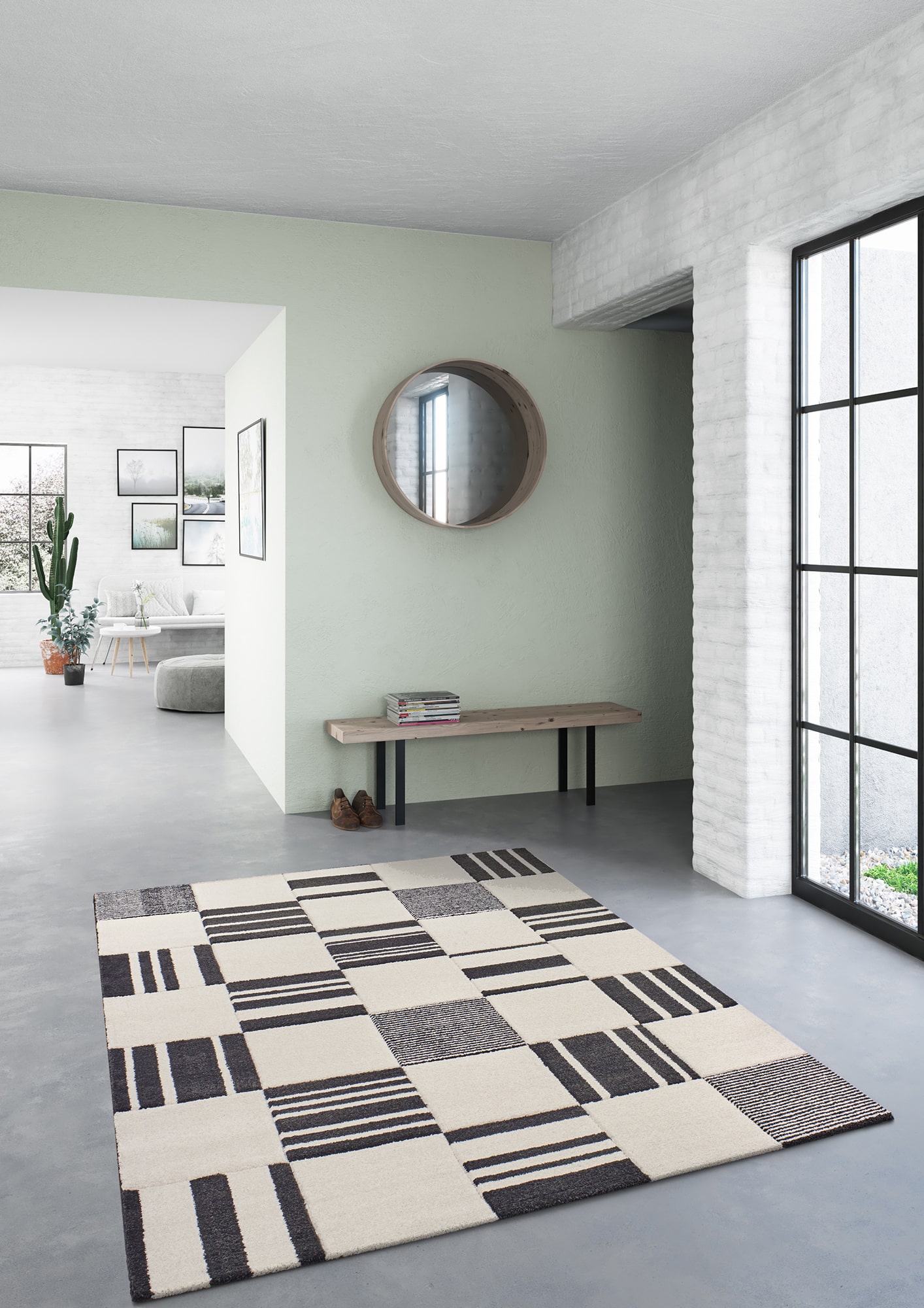 Modern living room with geometric patterned rug and minimalist decor.