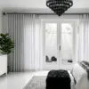 Gun metal 28mm double pole set with a decorative faceted crystal finial and matching hardware, shown in a modern interior.