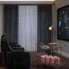 Elegant home theater with black leather chairs and a large screen.