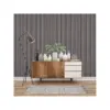 Modern interior with grey and black wall panel behind wooden sideboard.