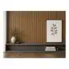 Modern interior wall with wooden slats, framed botanical art, and decorative vase and books.